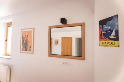 a mirror on a wall in a bathroom at Apartments Katrca Bežigrad in Ljubljana