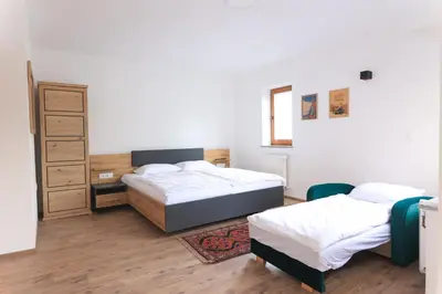 a bedroom with two beds and a dresser at Apartments Katrca Bežigrad in Ljubljana