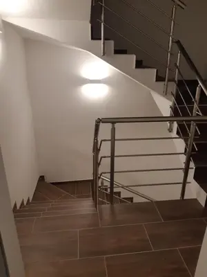 a staircase with a light and wooden floor at ALPSKA ROŽA in Kranjska Gora