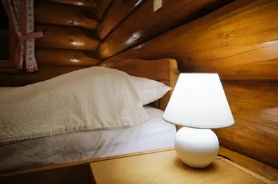 a bedroom with a bed and a lamp on a table at Mia Bella luxury chalet in Slovenske Konjice in Slovenske Konjice