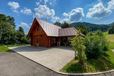 a large wooden cabin with a gambrel roof at Mia Bella luxury chalet in Slovenske Konjice in Slovenske Konjice