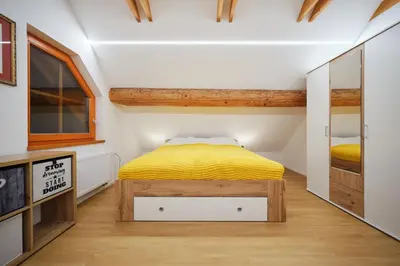 a bedroom with a bed with a yellow blanket at Mia Bella luxury chalet in Slovenske Konjice in Slovenske Konjice