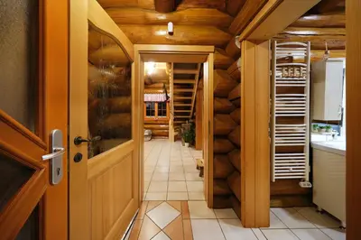 a hallway with a door leading to a kitchen with wooden walls at Mia Bella luxury chalet in Slovenske Konjice in Slovenske Konjice