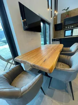 a wooden table and chairs in a kitchen at Alpine Wooden Villa with a View in Gozd Martuljek