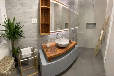 a bathroom with a sink and a mirror at Alpine Wooden Villa with a View in Gozd Martuljek