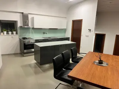 a kitchen with a wooden table and a table and chairs at Residence in Moravske Toplice