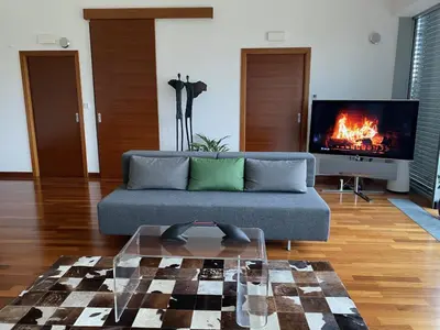 a living room with a couch and a tv at Residence in Moravske Toplice
