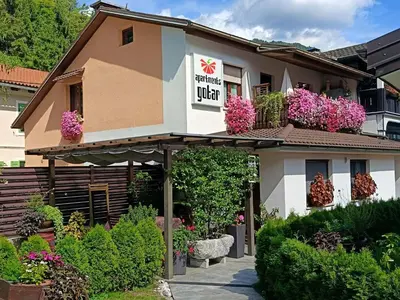 a hotel with flowers on the side of a building at Gotar Apartment with Garden in Kobarid