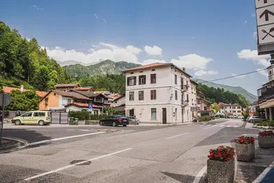 an empty street in a town with a building at Gotar Apartment with Garden in Kobarid