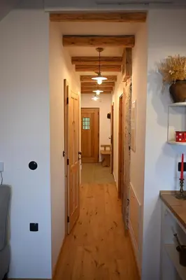 a hallway in a home with wooden floors and ceilings at SLO-ETNO HOUSE GOSTECE-Vintage Apartma in Mozirje