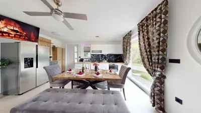 a kitchen and dining room with a table and chairs at Resort TimAJA - pool, massage pool, sauna in Trebnje