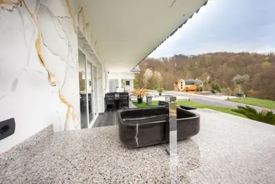 a bath tub sitting on top of a counter on a house at Resort TimAJA - pool, massage pool, sauna in Trebnje