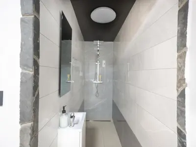 a white bathroom with a sink and a shower at Resort TimAJA - pool, massage pool, sauna in Trebnje