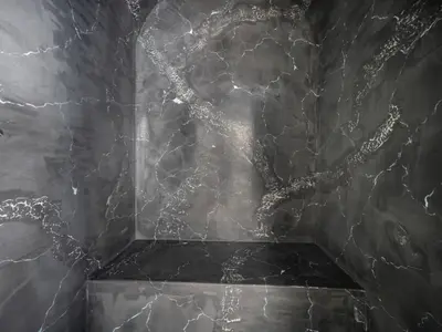 a black marble wall with a tree on it at Resort TimAJA - pool, massage pool, sauna in Trebnje