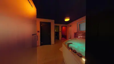 a bathroom with a tub and a bed in a room at Resort TimAJA - pool, massage pool, sauna in Trebnje