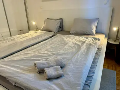 a bed with two towels sitting on top of it at Jenny Apartment with Jacuzzi in Brezovica