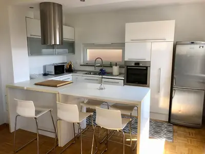 a kitchen with a white counter and white appliances at Jenny Apartment with Jacuzzi in Brezovica