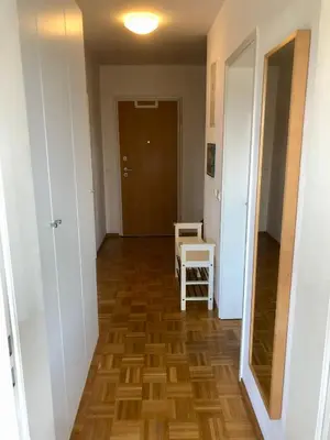 a hallway with a wooden floor and a door at Jenny Apartment with Jacuzzi in Brezovica