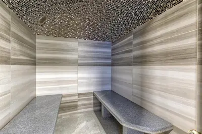 a room with a bench and a brick wall at Private Wellness Apartment in Trebnje
