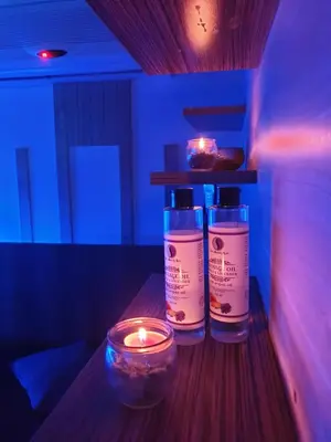 two bottles of soap and a candle on a table at Private Wellness Apartment in Trebnje