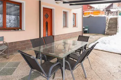 a glass table and chairs on a patio at Apartma Ana in Preserje