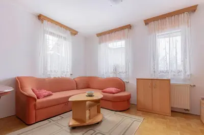 a living room with a couch and a table at Apartma Ana in Preserje