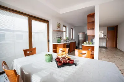 a kitchen with a table with a white table cloth at Apartment Ajdi in Ajdovščina