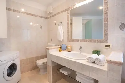 a bathroom with a sink and a washing machine at Apartment Ajdi in Ajdovščina