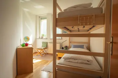 a bedroom with two bunk beds and a desk at Apartment Ajdi in Ajdovščina