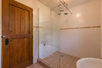 a bathroom with a shower with a glass door at House Jelenko in Bovec