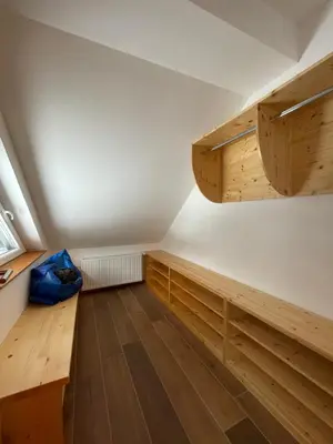 an attic room with wooden shelves and wooden floors at Apartma LD Puščava in Lovrenc na Pohorju