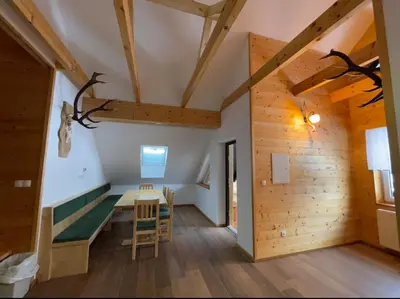 a room with a table and chairs in a building at Apartma LD Puščava in Lovrenc na Pohorju