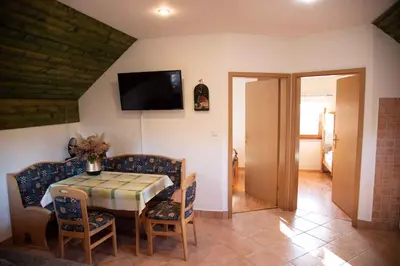 a dining room with a table and chairs and a television at Holiday home in Metlika Kranjska Krain 26051 in Metlika