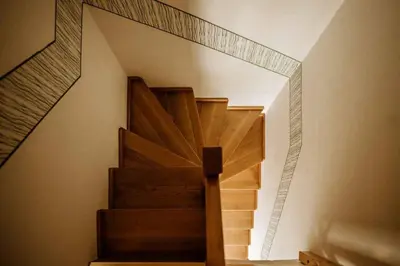 a wooden staircase with a mirror on the wall at Holiday home in Smarje pri Jelsah Stajerska Untersteiermark 26087 in Šmarje pri Jelšah