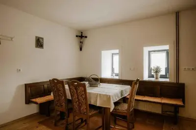 a dining room with a table and chairs and a cross at Holiday home in Smarje pri Jelsah Stajerska Untersteiermark 26087 in Šmarje pri Jelšah