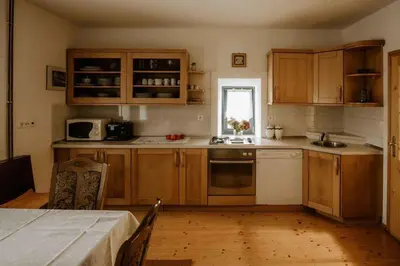 a kitchen with wooden cabinets and a table and a window at Holiday home in Smarje pri Jelsah Stajerska Untersteiermark 26087 in Šmarje pri Jelšah