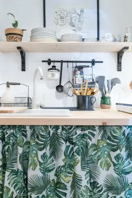 a kitchen with green and white wallpaper at Hiša Borov Gaj in Mojstrana