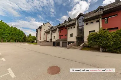 a row of buildings on the side of a street at Apartma Brlog Petra, Kranjska Gora in Kranjska Gora