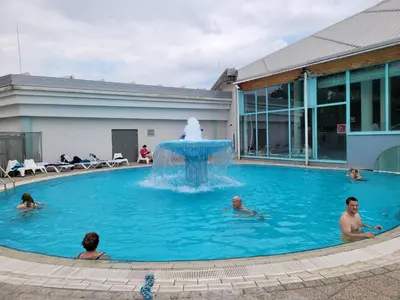 a group of people in a swimming pool with a fountain at Appartement Camp Terme Čatež P93 in Čatež ob Savi