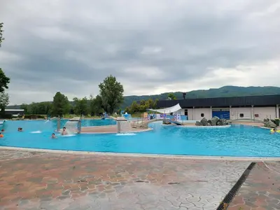 a large blue swimming pool with people in it at Appartement Camp Terme Čatež P93 in Čatež ob Savi