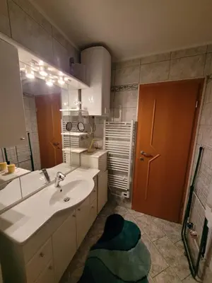 a bathroom with a sink and a large mirror at Appartement Camp Terme Čatež P93 in Čatež ob Savi