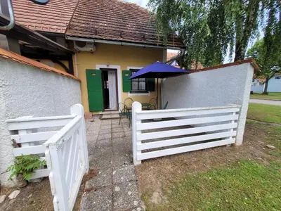 a white fence in front of a house at Appartement Camp Terme Čatež P93 in Čatež ob Savi