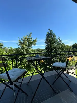 a table and two chairs on a balcony at Apartments Heart in Ljubljana