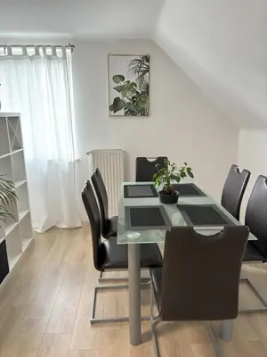 a dining room with a table and black chairs at Apartments Heart in Ljubljana