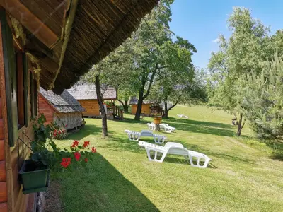 a group of white chairs sitting on the grass at Camping Silva in Ljutomer