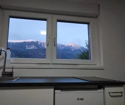 a kitchen window with a view of a mountain at Tilka`s house in Blejska Dobrava