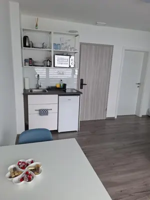 a kitchen with a counter and a table with shoes on it at Tilka`s house in Blejska Dobrava