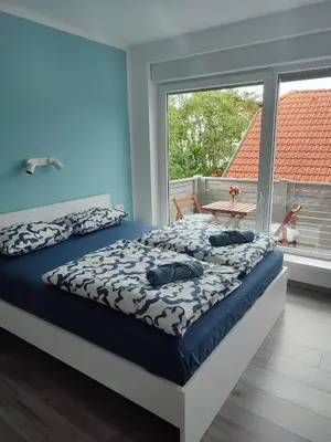 a bedroom with a bed and a large window at Tilka`s house in Blejska Dobrava