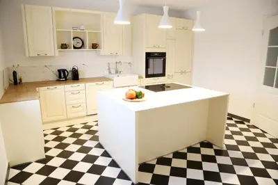 a white kitchen with a bowl of fruit on a counter at Maribor Luxury Country House Volicina 5* in Spodnja Voličina