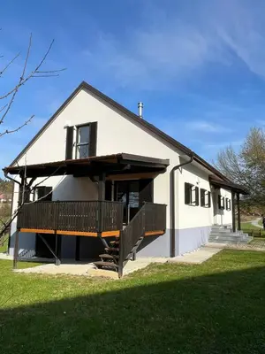 a white house with a porch and a balcony at Maribor Luxury Country House Volicina 5* in Spodnja Voličina